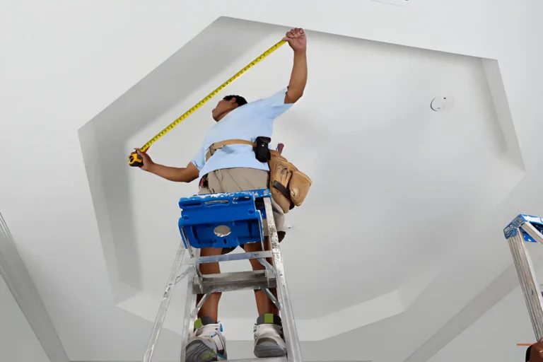 man measuring ceiling in preparation for cutting coving