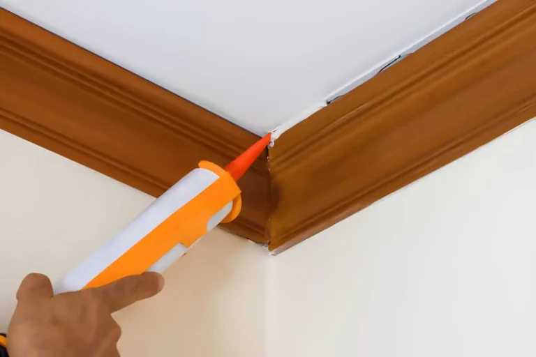 man applying adhesive to install coving